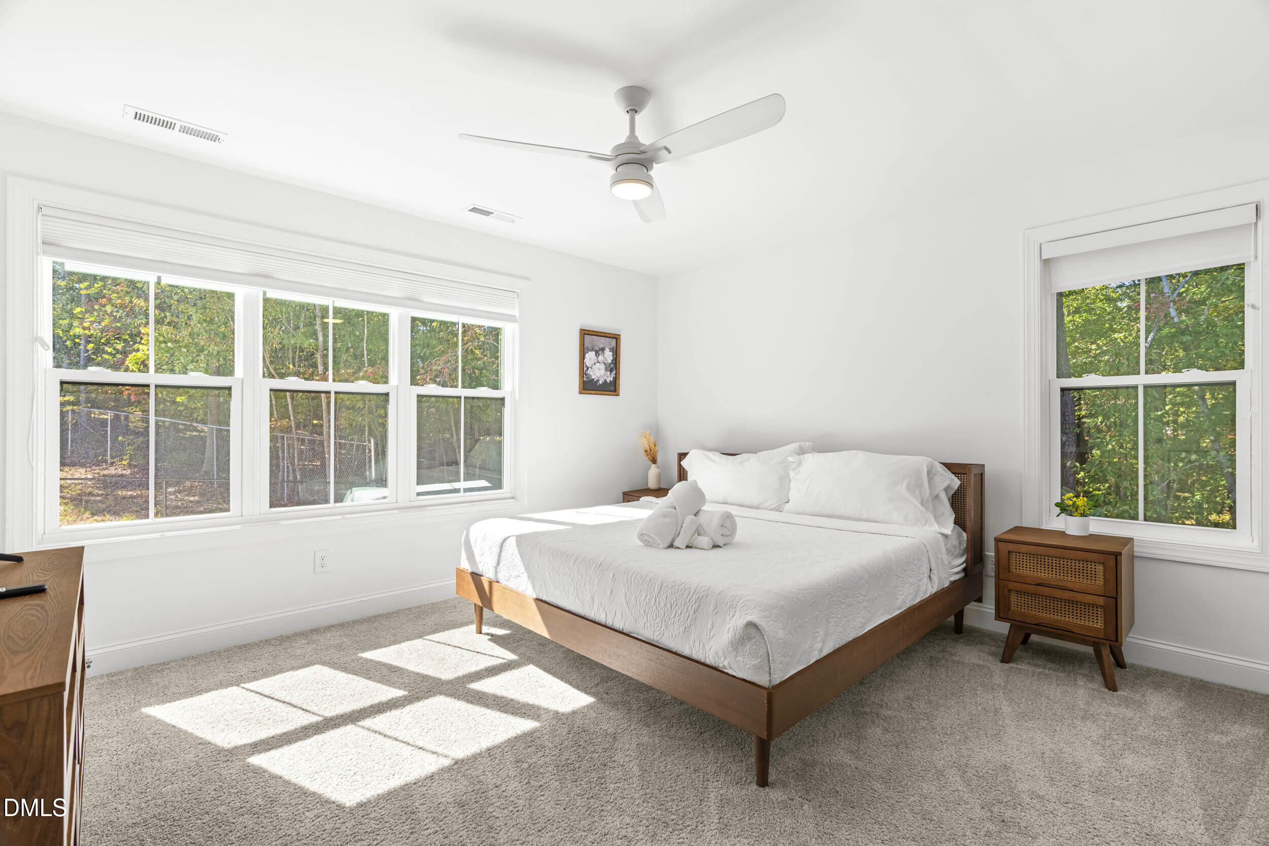 5631 Johnson Woods Court Raleigh, NC 27609 - Photo 14 of 34 a bed sitting in a room next to a window