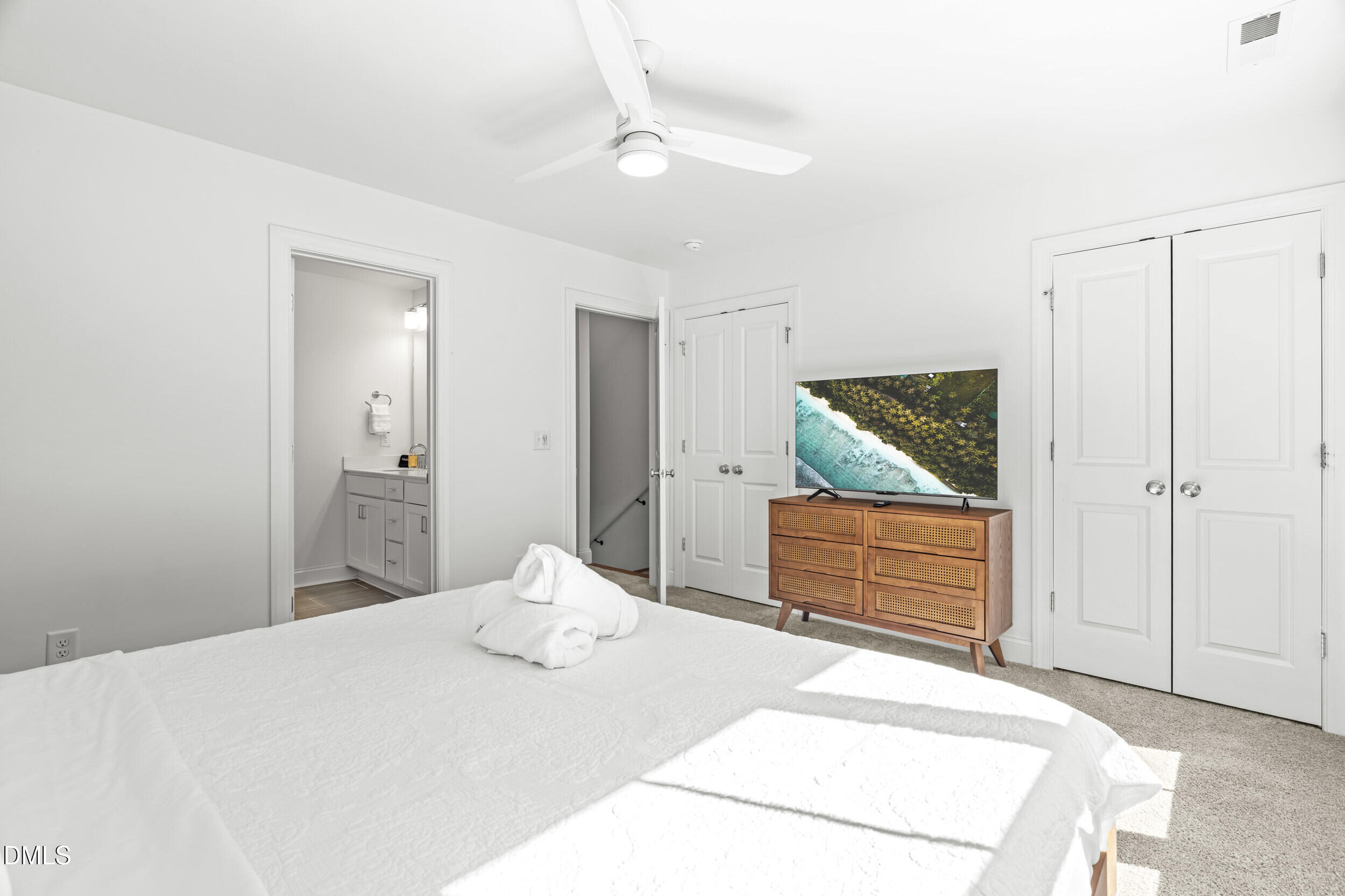 5631 Johnson Woods Court Raleigh, NC 27609 - Photo 15 of 34 a bedroom with a bed and a dresser