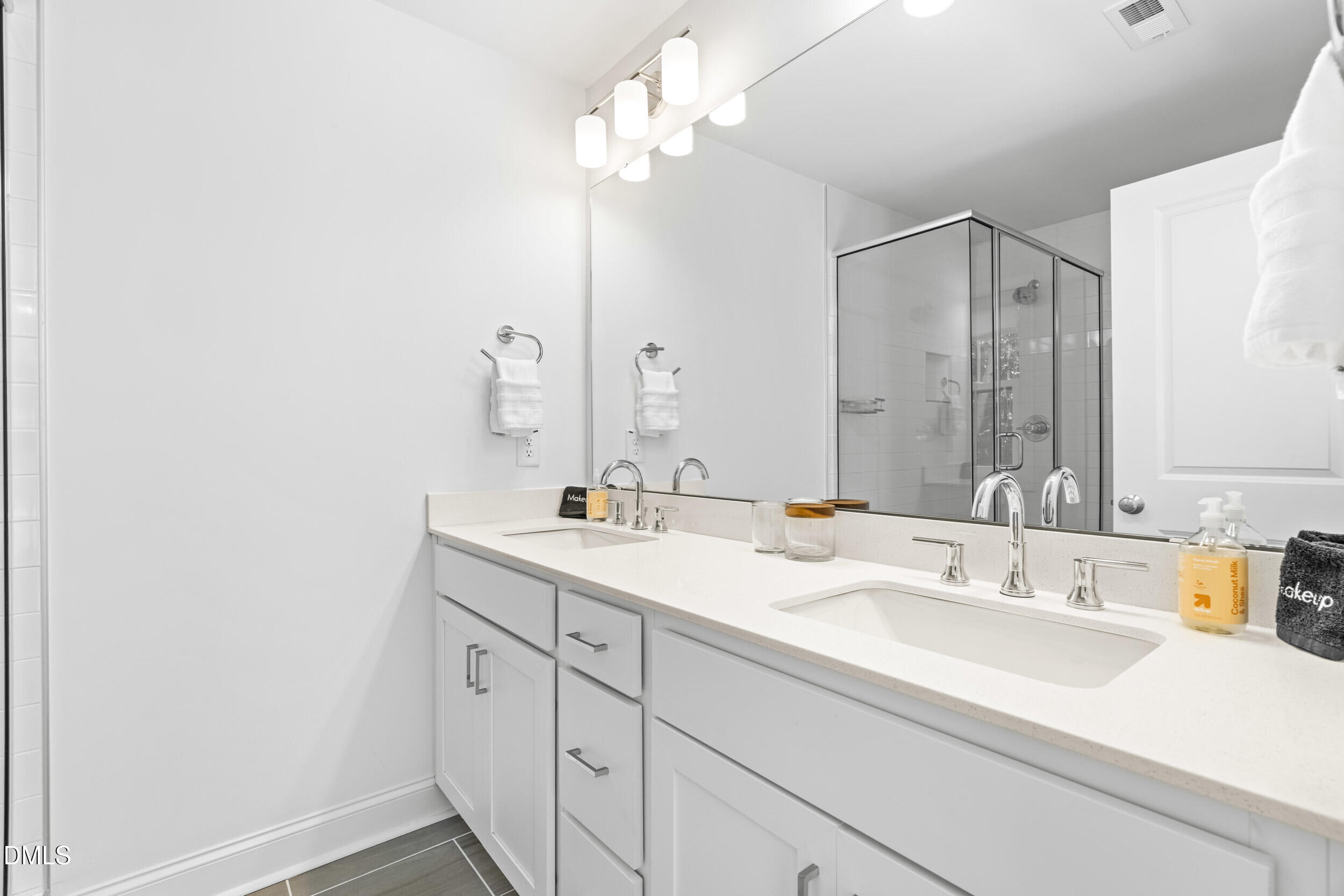5631 Johnson Woods Court Raleigh, NC 27609 - Photo 16 of 34 a bathroom with a sink vanity granite and a mirror