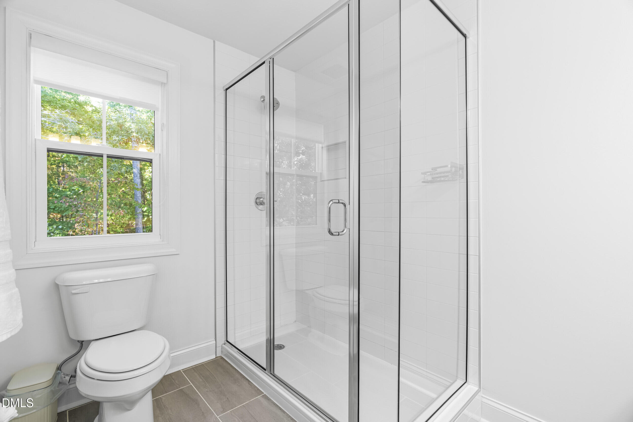 5631 Johnson Woods Court Raleigh, NC 27609 - Photo 17 of 34 a bathroom with a shower and a toilet