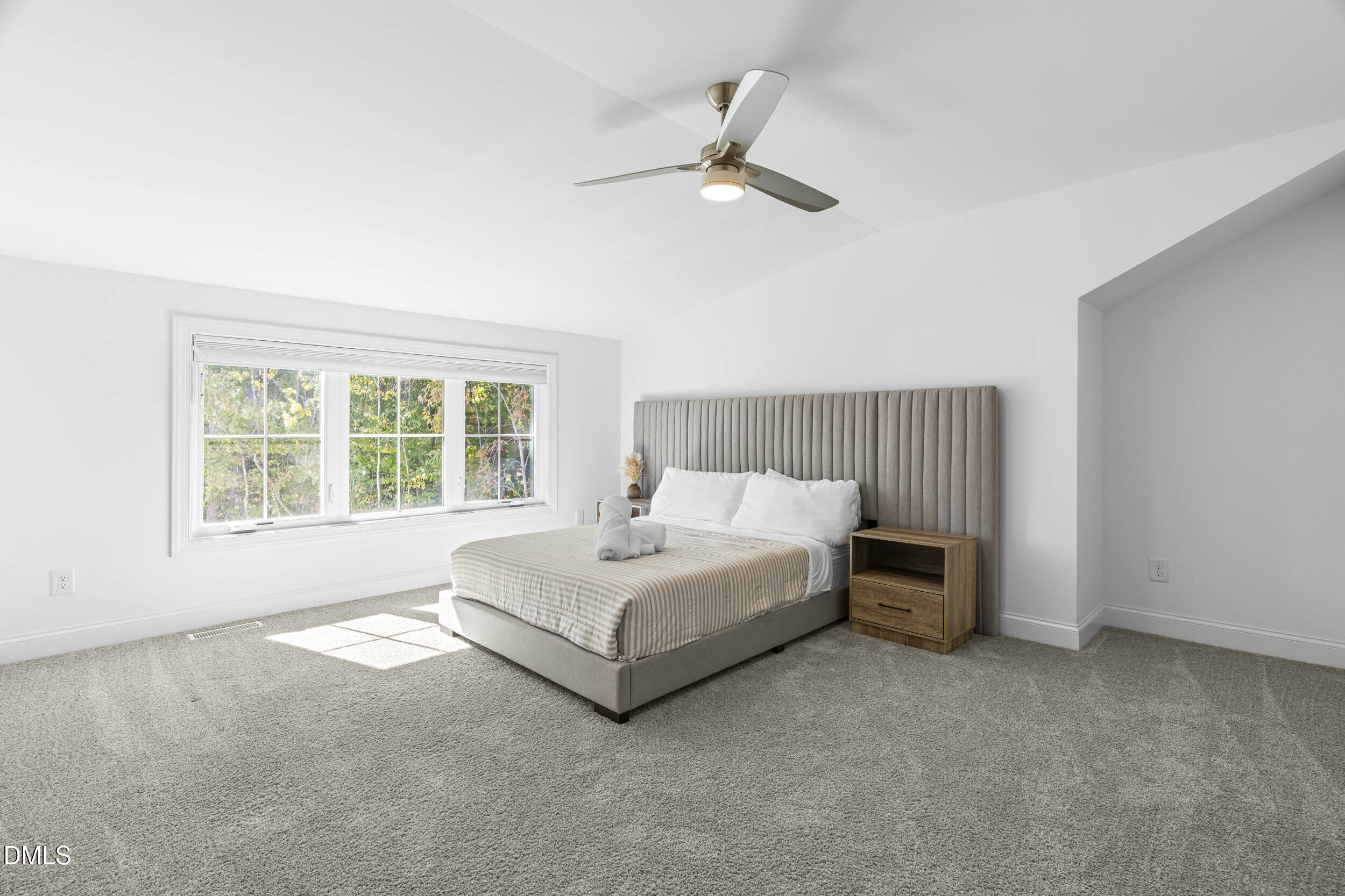 5631 Johnson Woods Court Raleigh, NC 27609 - Photo 23 of 34 a spacious bedroom with a bed and a window