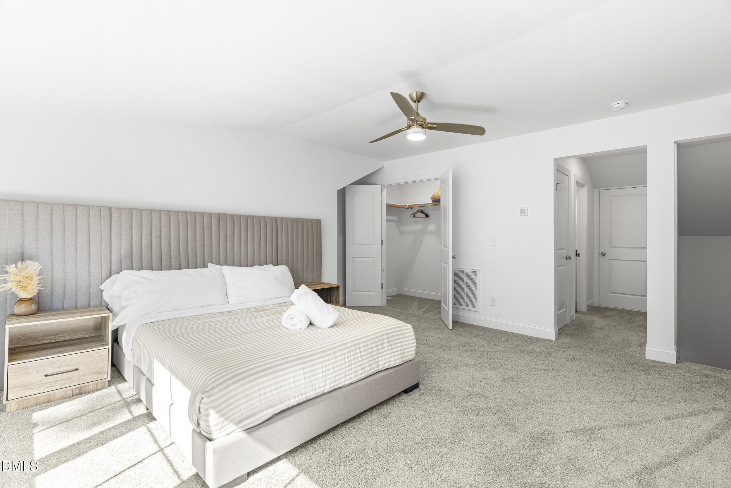 5631 Johnson Woods Court Raleigh, NC 27609 - Photo 24 of 34 a bedroom with a bed and a ceiling fan