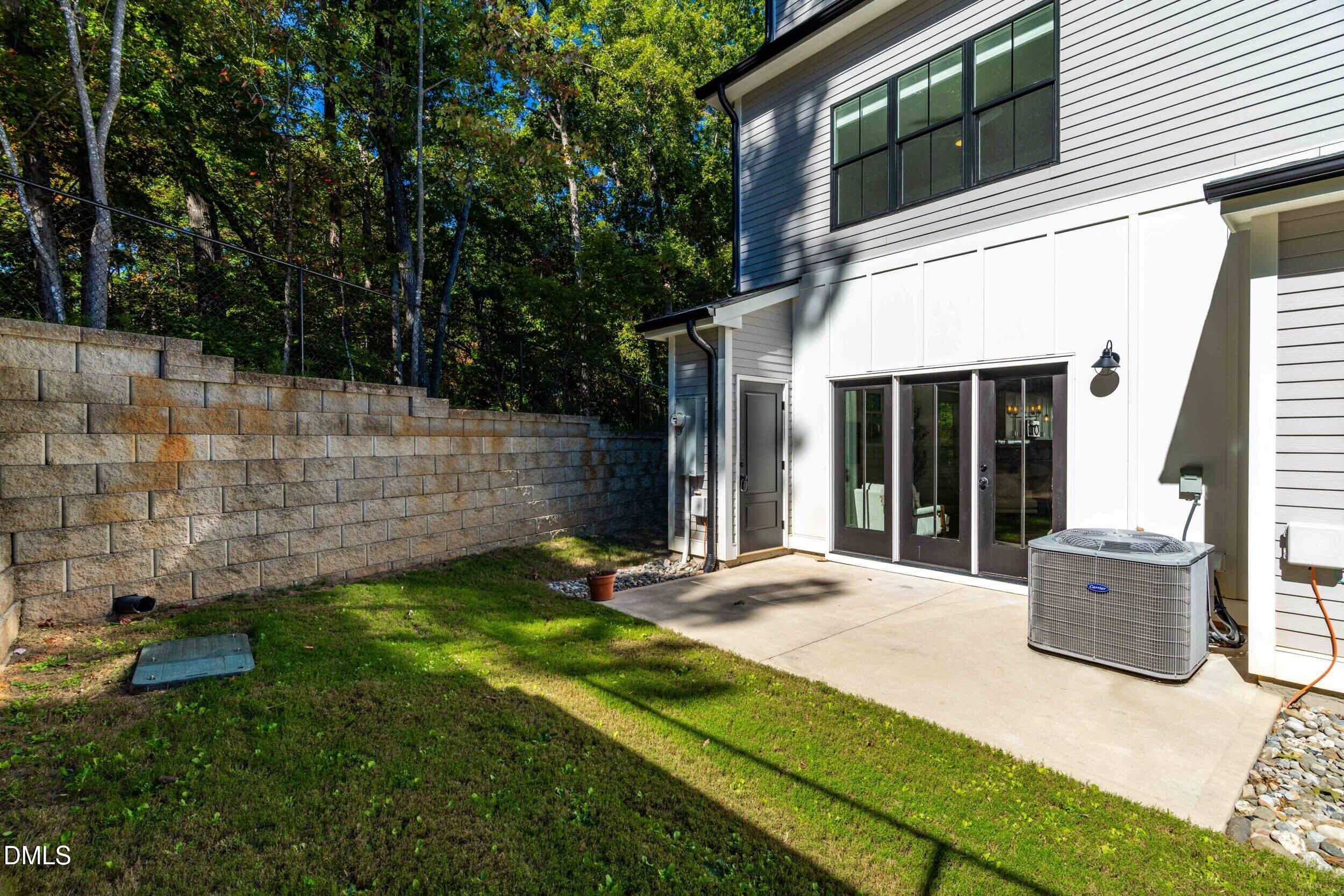 5631 Johnson Woods Court Raleigh, NC 27609 - Photo 27 of 34 a view of house with backyard and garden