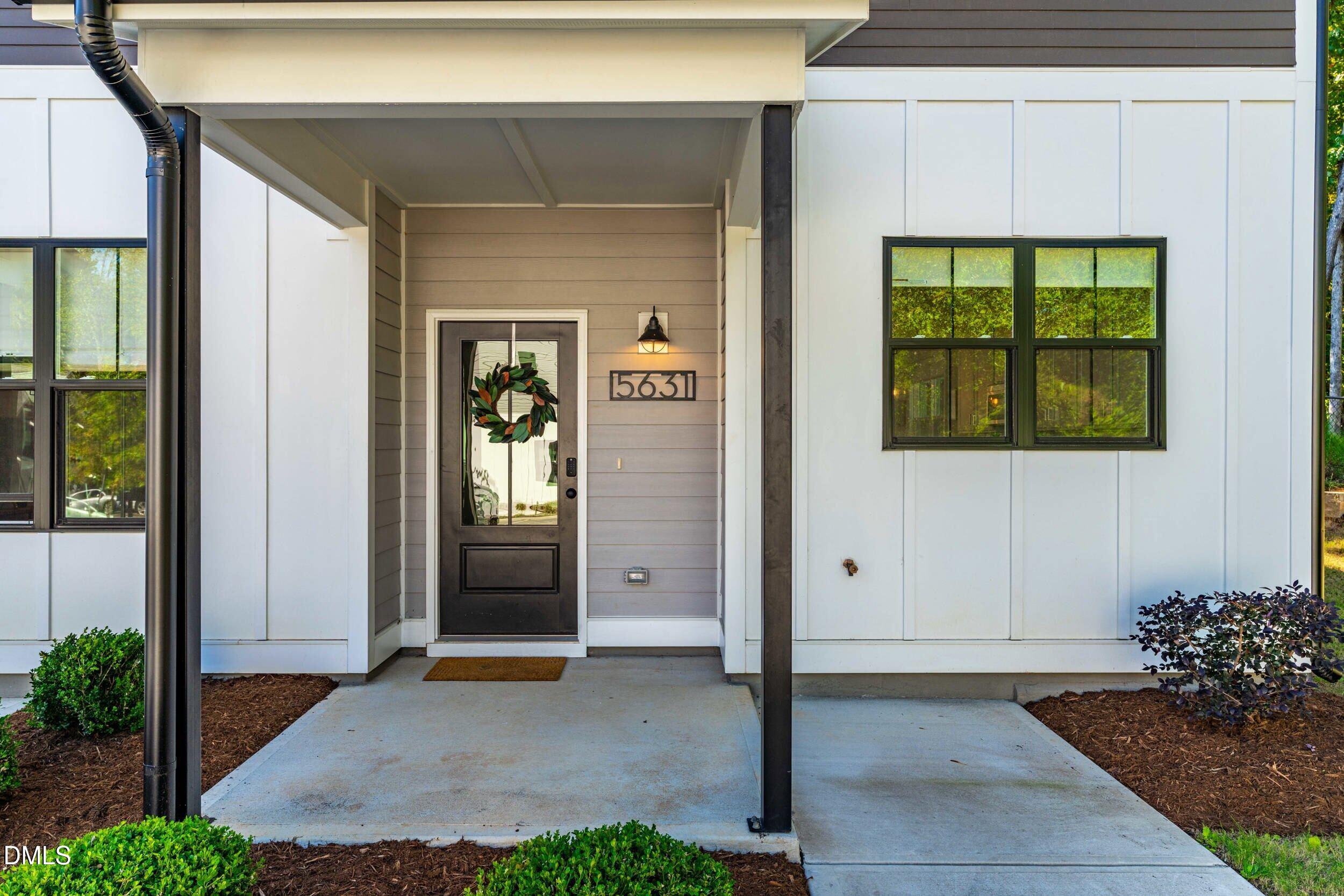5631 Johnson Woods Court Raleigh, NC 27609 - Photo 3 of 34 a front view of a house with a yard