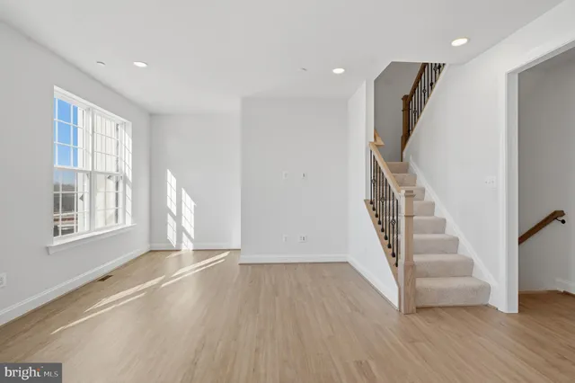 a view of entryway with wooden floor and stairs