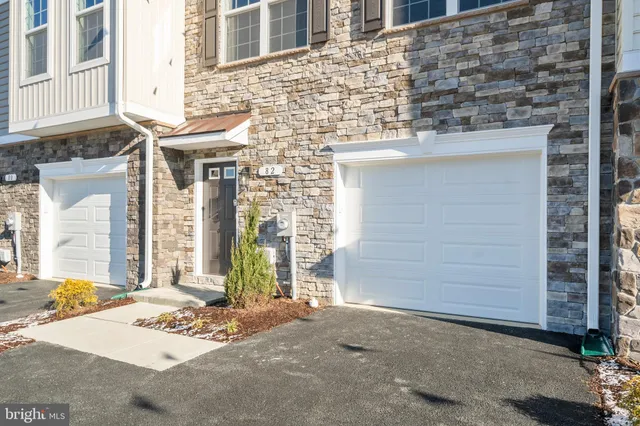 a view of a brick house with large windows