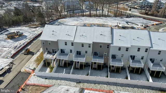 a view of a patio with table and chairs with wooden floor and fence
