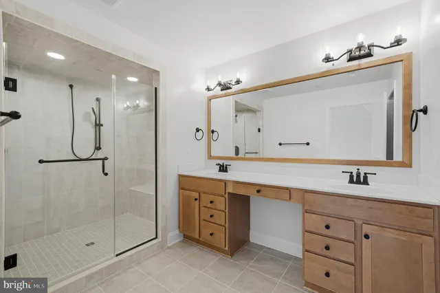 a spacious bathroom with a double vanity sink mirror and double