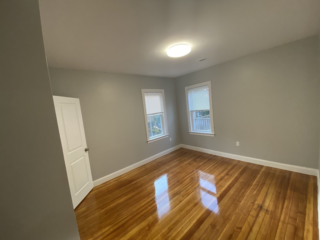 27 Juliette Street Boston, MA 02122 - Photo 15 of 37 a view of empty room with wooden floor and fan