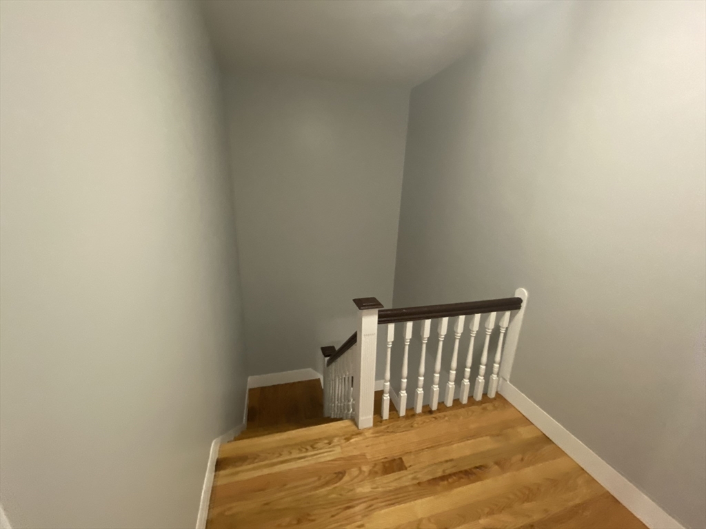 27 Juliette Street Boston, MA 02122 - Photo 16 of 37 a bedroom with a bed and wooden floor
