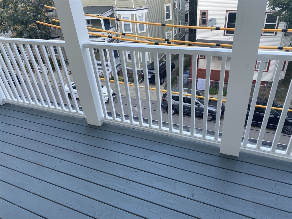 27 Juliette Street Boston, MA 02122 - Photo 17 of 37 a view of balcony with wooden floor and fence