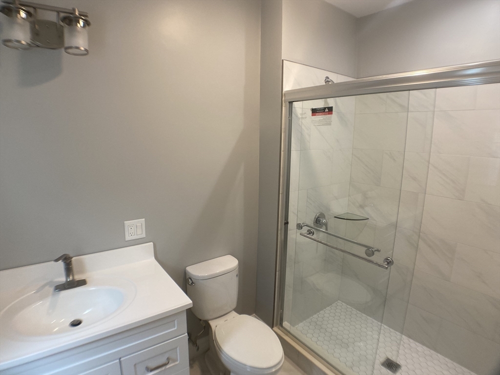 27 Juliette Street Boston, MA 02122 - Photo 20 of 37 a bathroom with a shower toilet and sink