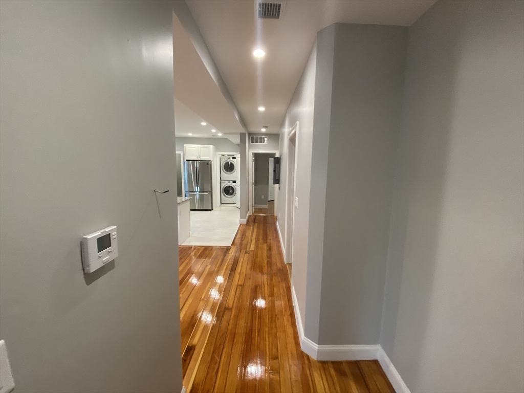 27 Juliette Street Boston, MA 02122 - Photo 2 of 37 a view of a hallway with wooden floor