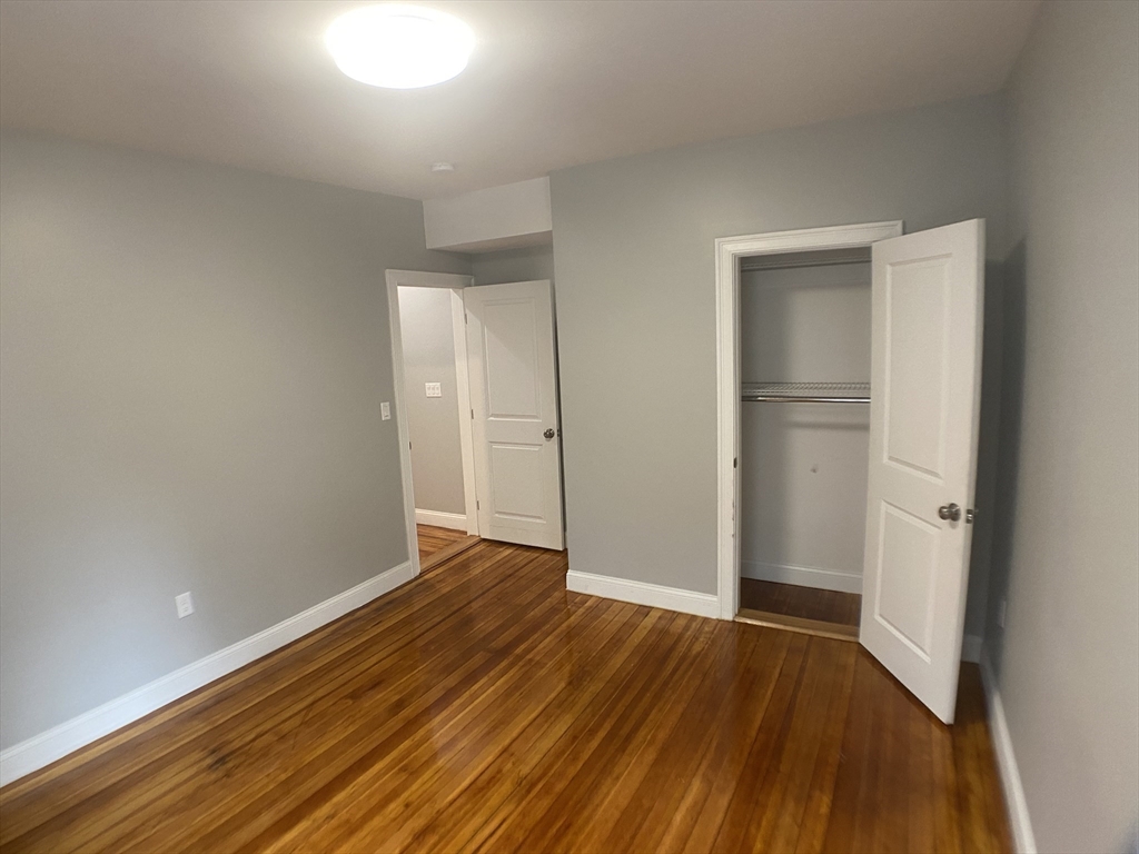 27 Juliette Street Boston, MA 02122 - Photo 22 of 37 a view of an empty room with wooden floor