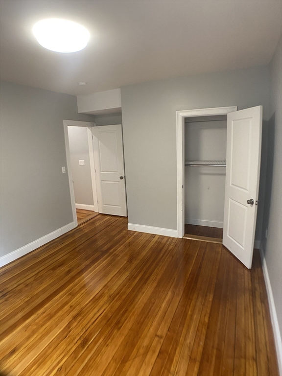 27 Juliette Street Boston, MA 02122 - Photo 23 of 37 a view of an empty room with wooden floor and a window