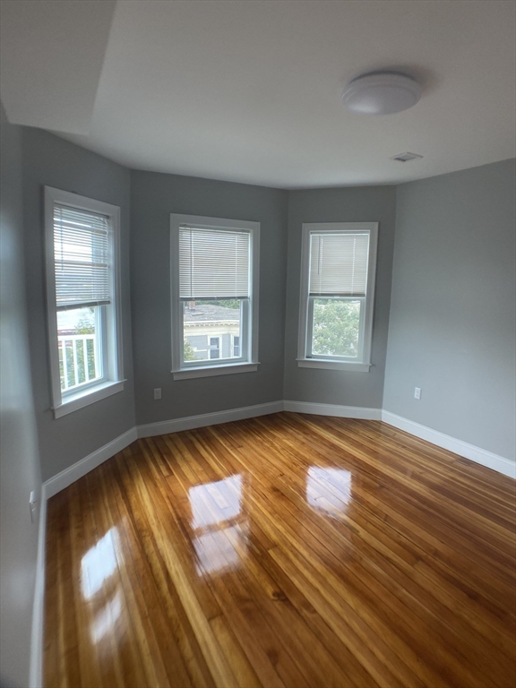 27 Juliette Street Boston, MA 02122 - Photo 26 of 37 a view of empty room with window and wooden floor
