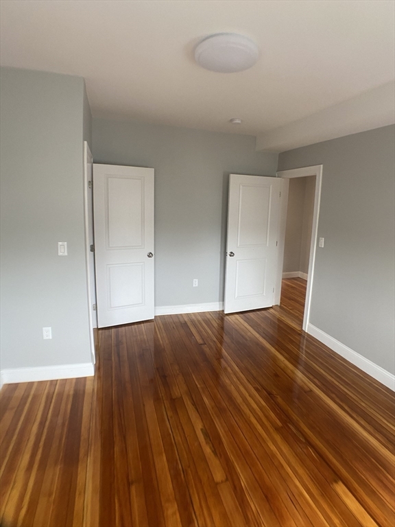 27 Juliette Street Boston, MA 02122 - Photo 27 of 37 wooden floor in an empty room