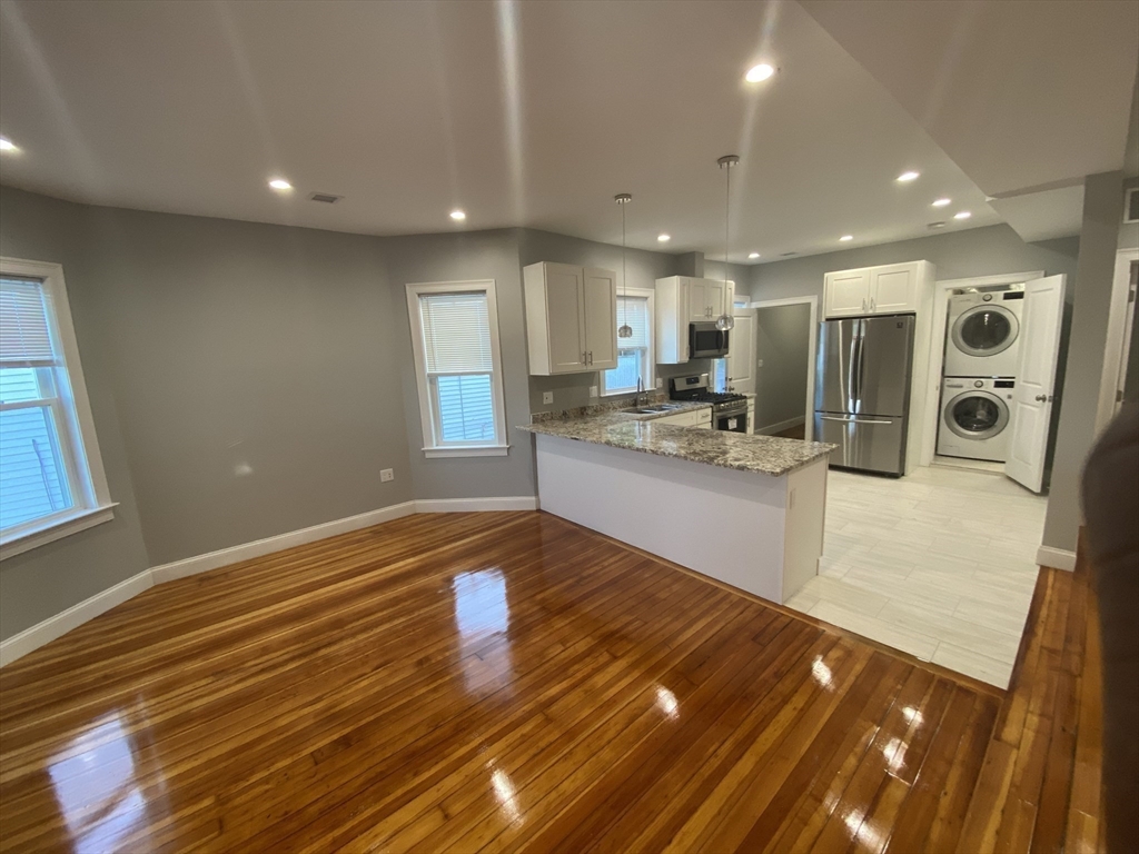 27 Juliette Street Boston, MA 02122 - Photo 6 of 37 a view of kitchen and dining room with wooden floor