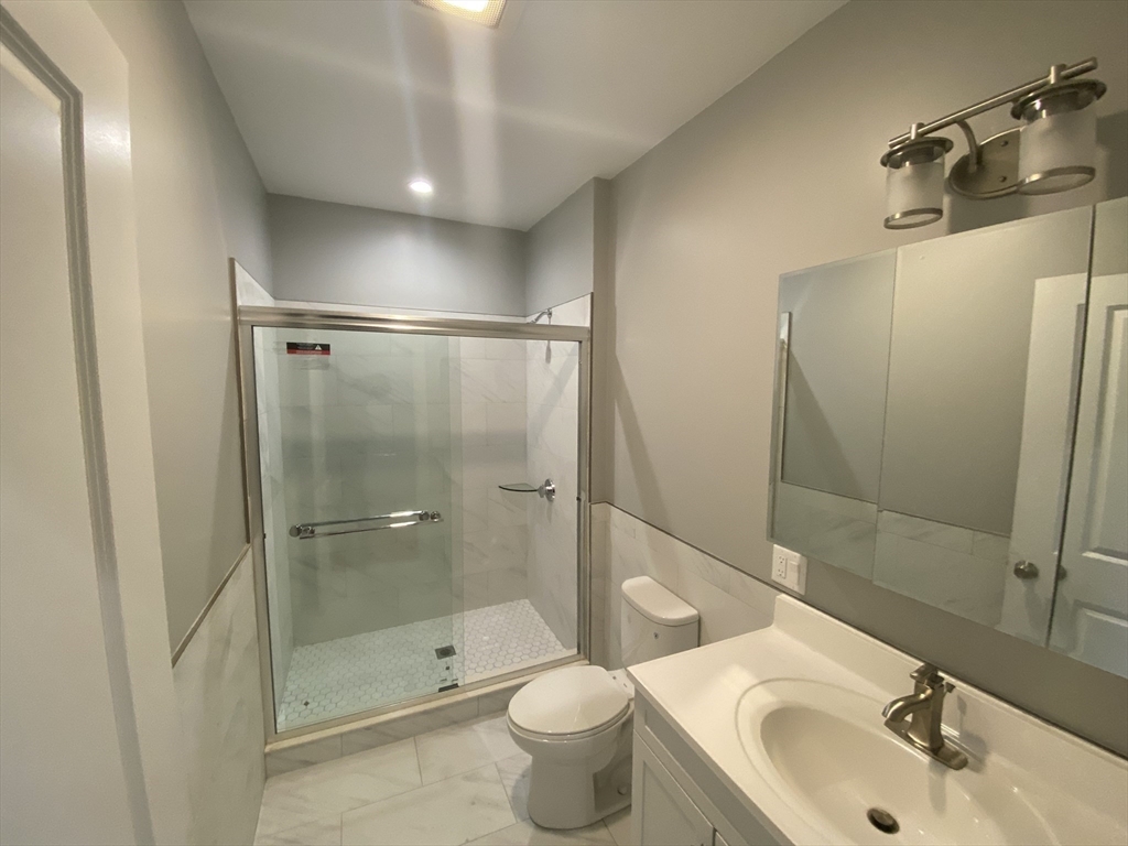 27 Juliette Street Boston, MA 02122 - Photo 10 of 37 a bathroom with a sink toilet and shower