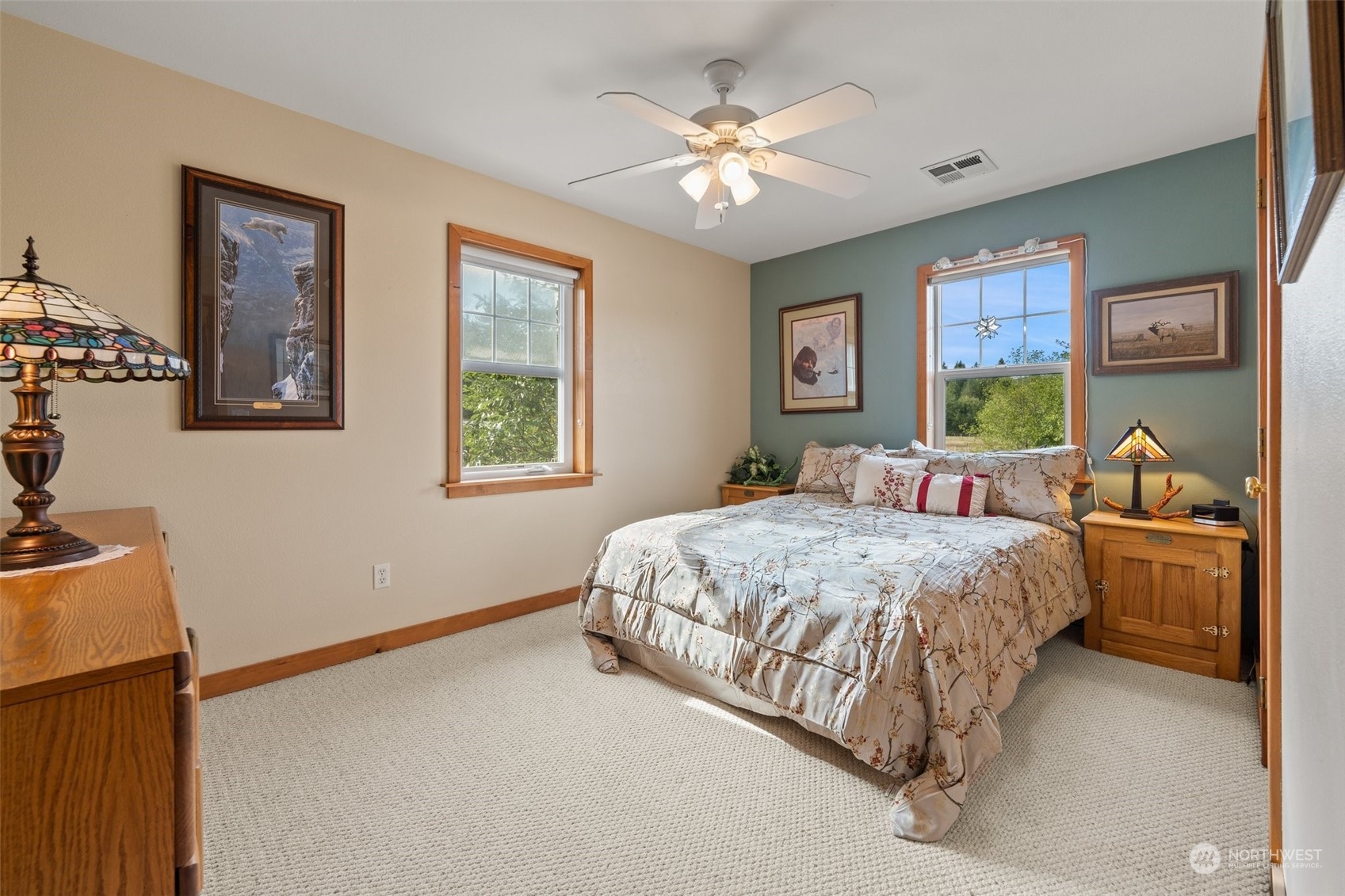 181 Laurence Lane Southwest Rochester, WA 98579 - Photo 19 of 40 a bedroom with a large bed and a chandelier