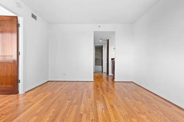 a view of walk in closet with empty racks