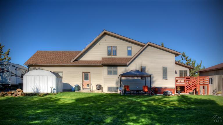 63578 Boyd Acres Road Bend, OR 97701 - Photo 11 of 22 a front view of a house with a garden and yard