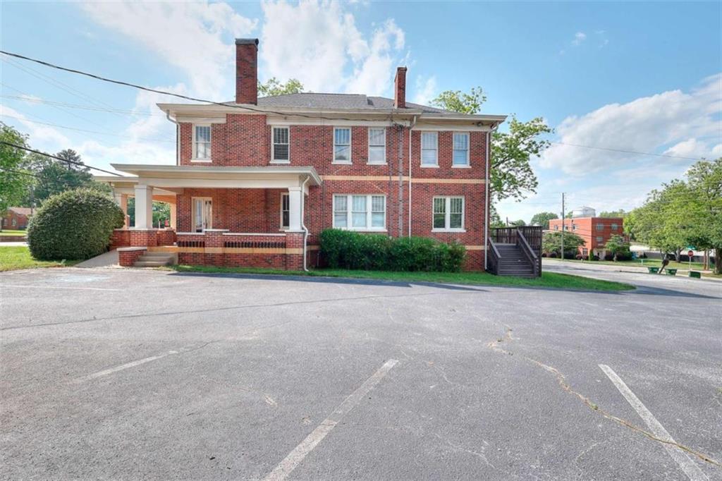 338 North Broad Street Monroe, GA 30655 - Photo 11 of 67 a front view of a house with a yard and garage