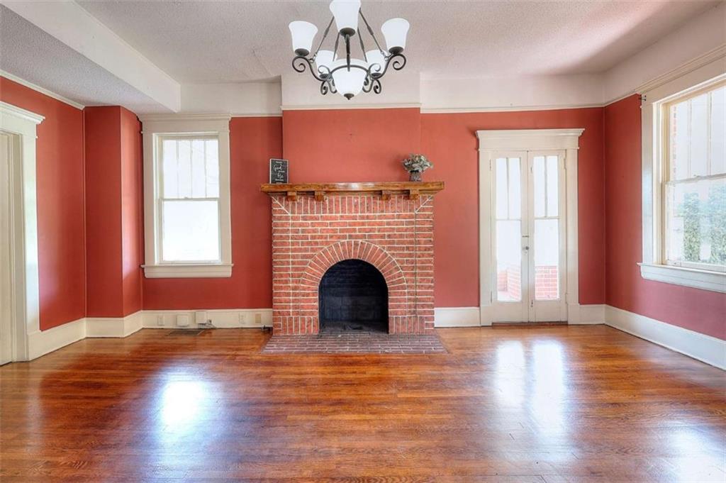 338 North Broad Street Monroe, GA 30655 - Photo 24 of 67 a view of a livingroom with a fireplace wooden floor and windows