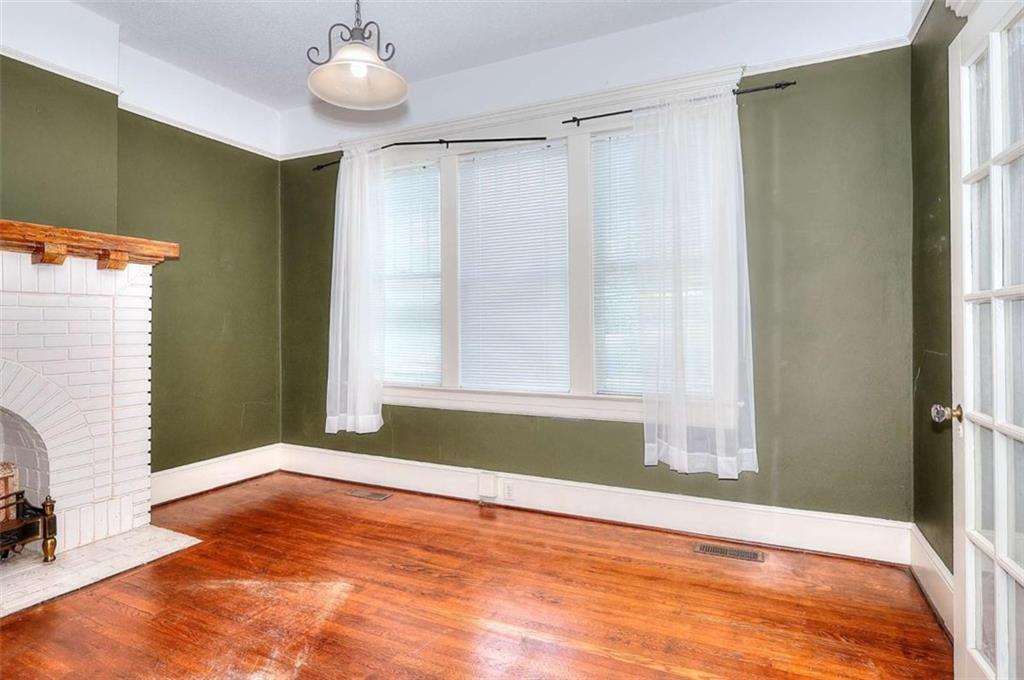 338 North Broad Street Monroe, GA 30655 - Photo 26 of 67 a view of an empty room with wooden floor and a window