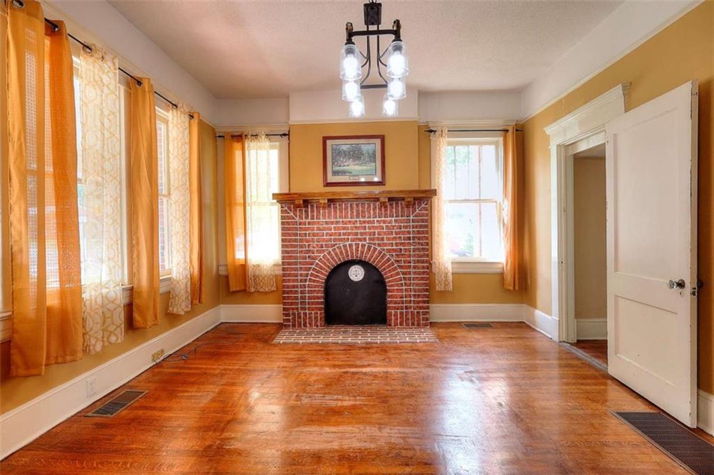338 North Broad Street Monroe, GA 30655 - Photo 28 of 67 a view of a livingroom with a fireplace window and wooden floor