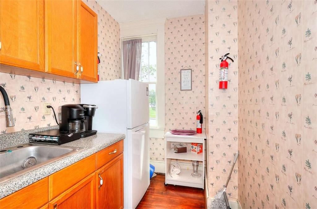 338 North Broad Street Monroe, GA 30655 - Photo 37 of 67 a kitchen with a refrigerator and a sink