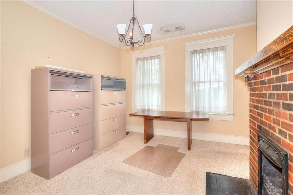 338 North Broad Street Monroe, GA 30655 - Photo 50 of 67 a spacious bedroom with a bed and a chandelier