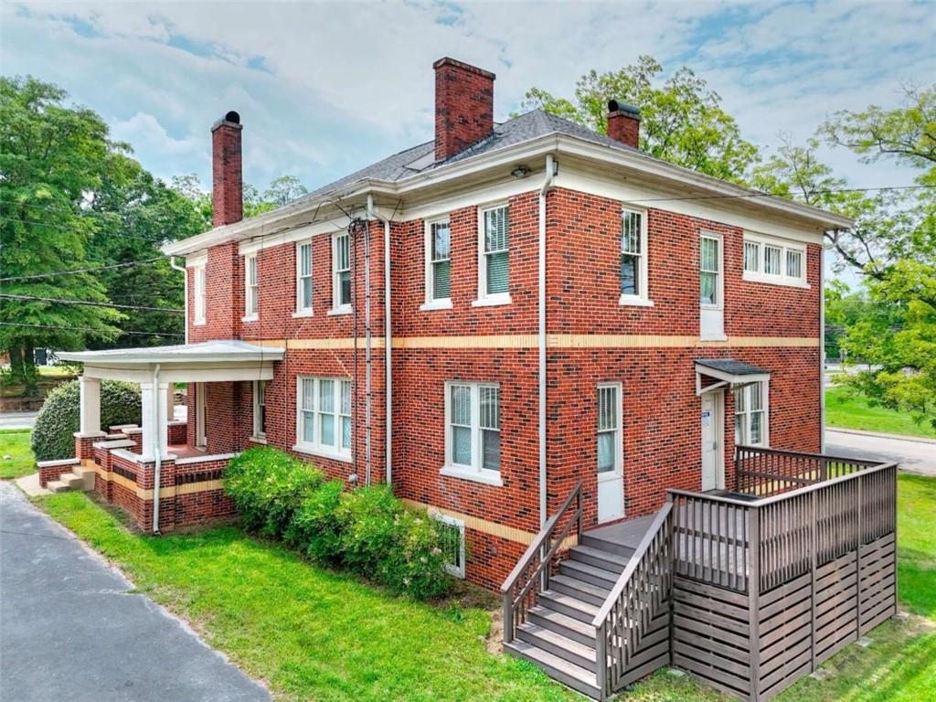 338 North Broad Street Monroe, GA 30655 - Photo 6 of 67 a front view of a house with garden
