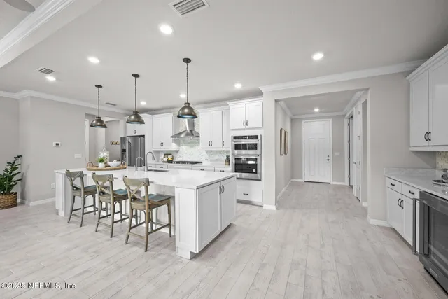 a kitchen with stainless steel appliances kitchen island granite countertop a sink and cabinets
