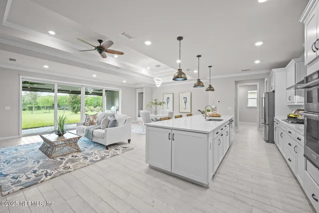 a living room with furniture ceiling fan and a rug