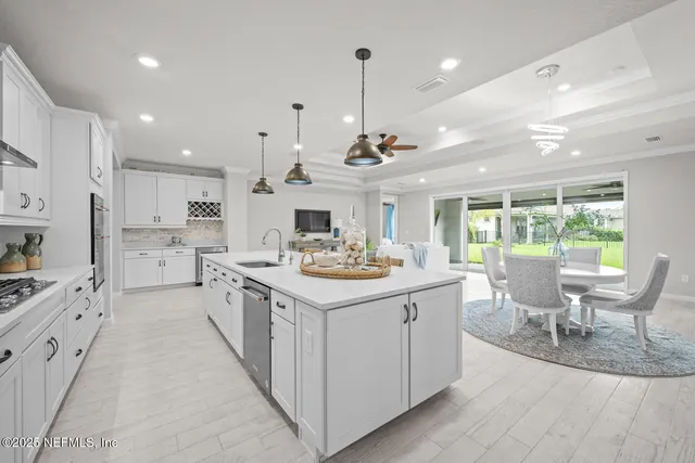 a living room with furniture and kitchen view