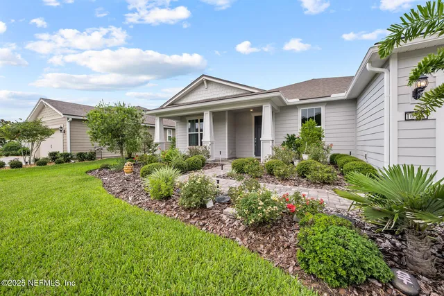 a front view of a house with a garden