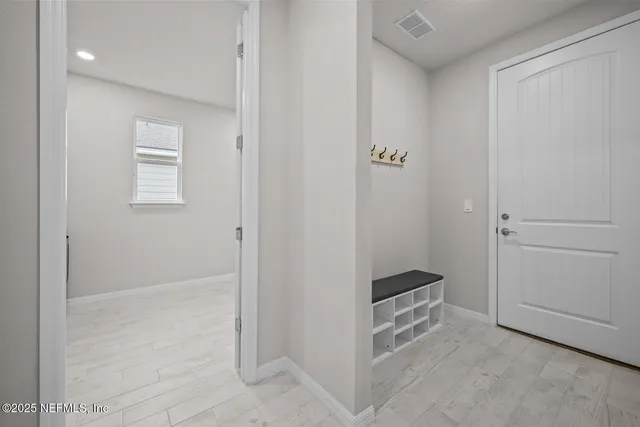 a view of a dining room with furniture large windows and wooden floor