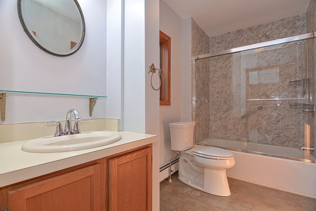 88 Townsend Road, Unit A Shirley, MA 01464 - Photo 16 of 35 a bathroom with a sink a toilet and a mirror