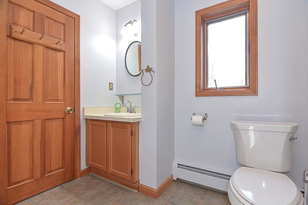 88 Townsend Road, Unit A Shirley, MA 01464 - Photo 17 of 35 a bathroom with a toilet a sink and a window