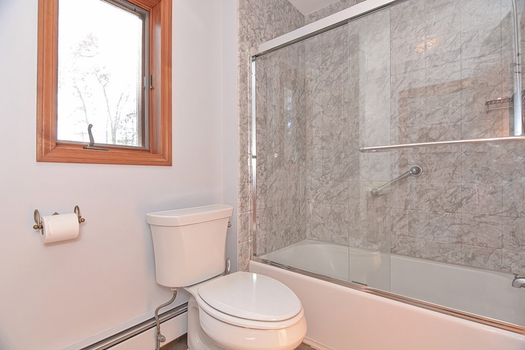 88 Townsend Road, Unit A Shirley, MA 01464 - Photo 19 of 35 a white toilet sitting next to a bath tub shower