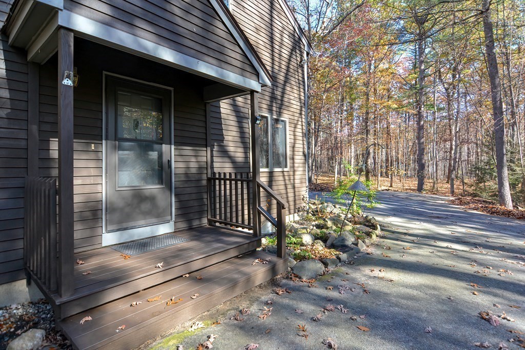 88 Townsend Road, Unit A Shirley, MA 01464 - Photo 28 of 35 a view of a brick house with a large window and wooden fence