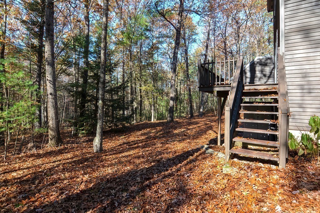 88 Townsend Road, Unit A Shirley, MA 01464 - Photo 30 of 35 a view of a yard with wooden fence and trees
