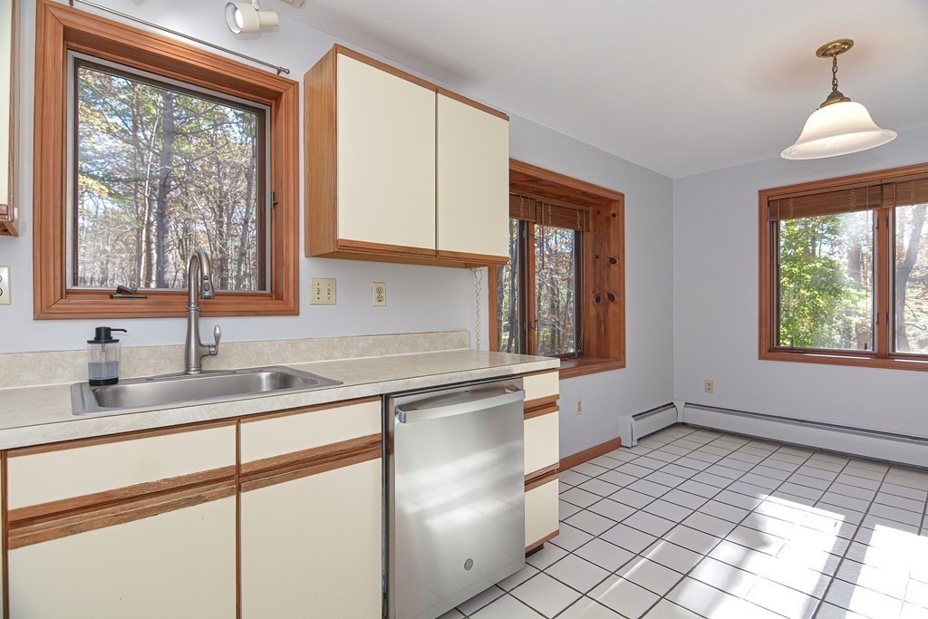 88 Townsend Road, Unit A Shirley, MA 01464 - Photo 9 of 35 a kitchen with a sink window and cabinets