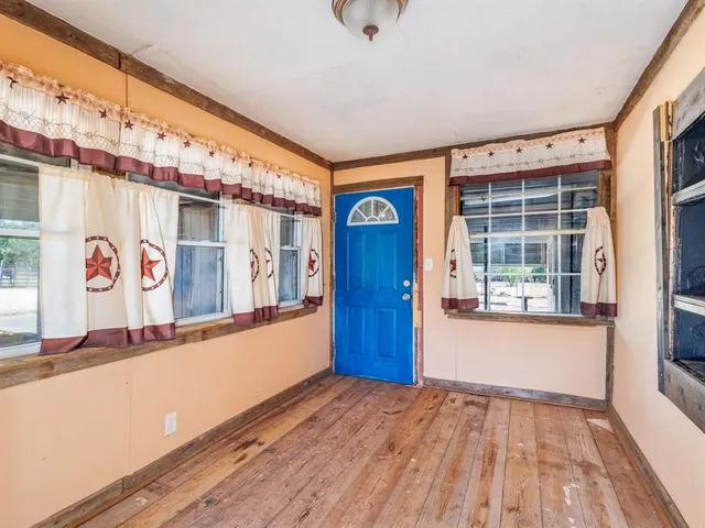 a view of an entryway with wooden floor