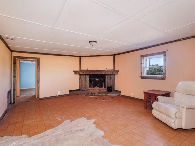 a view of livingroom with furniture and a fireplace