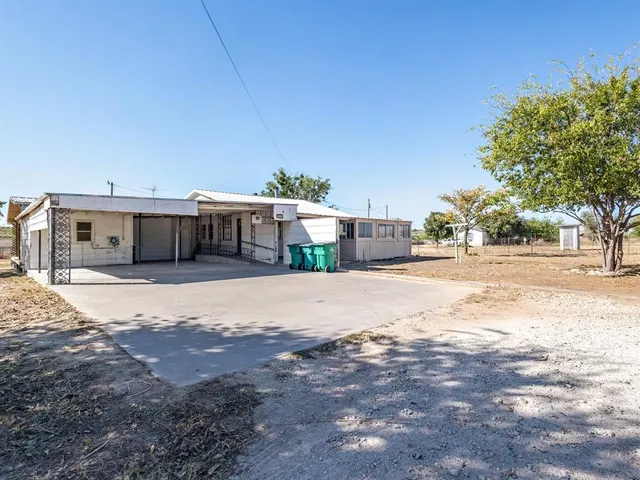 a view of a house next to a yard and road