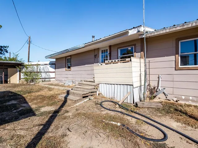 a view of a house with wooden fence