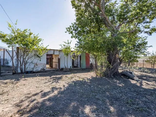 a view of a house with a tree