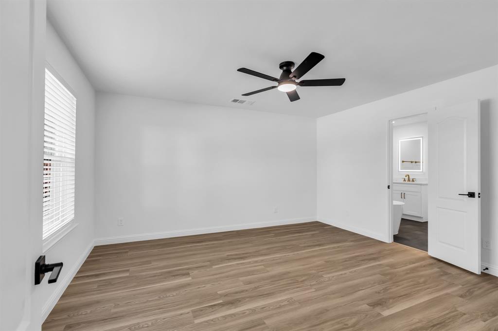 906 Thistle Circle Allen, TX 75002 - Photo 19 of 40 a view of empty room with wooden floor and window